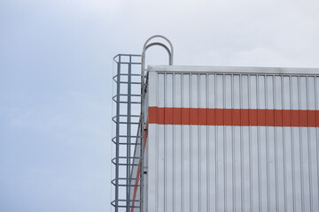 A industry factory building with a ladder on the side.