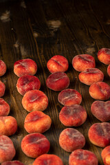 a pile of ripe washed peaches on the table
