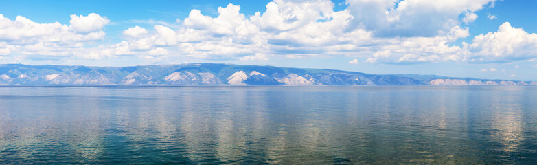 Baikal Lake in summer. Panoramic view of Small Sea strait and Primorskiy mountain range from Olkhon Island. Scenic seascape. Nature background. Panorama, banner