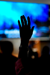 Silhouette Hand Raising Worshipper, blurred background