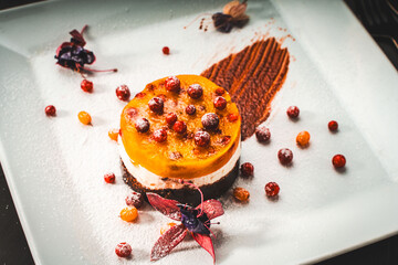 Dessert or cake made of mango, sea buckthorn and lingonberry jelly with cottage cheese or cream and...