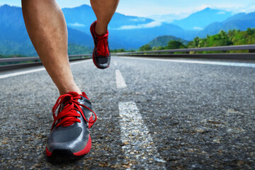 Closeup of young man legs running on the street in the morning