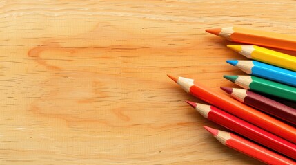 Obraz premium pencils on light yellow background wooden table