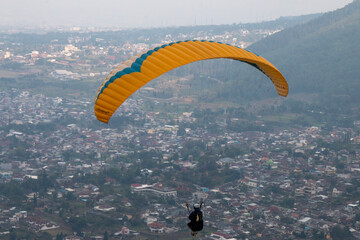 Some people are paragliding on a mountain with beautiful views