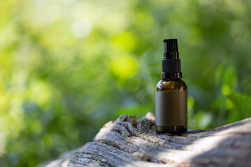 Brown Glass Spray Bottle on Tree Trunk. Copy Sapce.