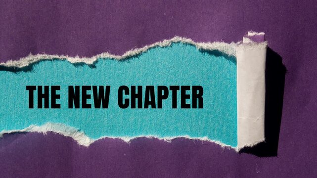 The new chapter message writing on ripped torn purple paper on blue background. Conceptual the new chapter symbol. Copy space.