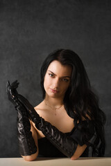 Beautiful dark-haired woman in black long gloves