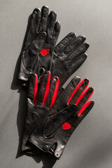 Two pairs of black gloves with red elements