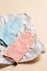 A creative pair of gloves on on crumpled paper