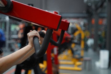 Fototapeta premium Young woman doing exercises in fitness gym.