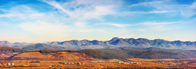 panorama of romania countryside in morning light. distant ridge. autumnal landscape in mountains. grassy field and rolling hills. rural scenery