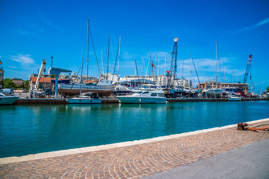 A view of boats moored in the estuary and on the river bank close to the sea in Rimini, Italy in summertime