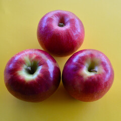 A view of three Pink Lady apples on the table. 
