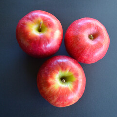 A view of three Pink Lady apples on the table. 