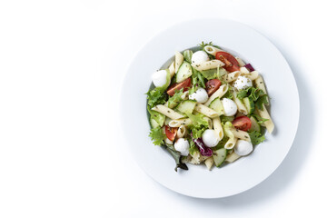 Pasta salad with vegetables and mozzarella cheese isolated on white background. Top view. Copy space