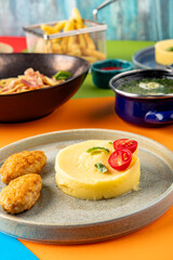 Mashed potatoes with cutlets and sauce on a background of spaghetti and broth. Set of food of the children's menu. Dinner. Restaurant service