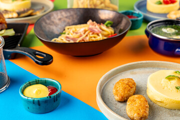 Mashed potatoes with cutlets and sauce on a background of spaghetti and broth. Set of food of the children's menu. Dinner. Restaurant service