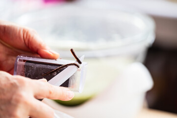 A person holds a bar of soap, carefully carving its edges with a knife, shaping and refining it into a more beautiful form with precision and attention to detail.