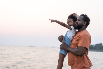 African love family father and daughter enjoying a carefree moment strength and happiness as he lifts his young daughter, childhood, joy, leisure, parenting and outdoor activities, Father day.