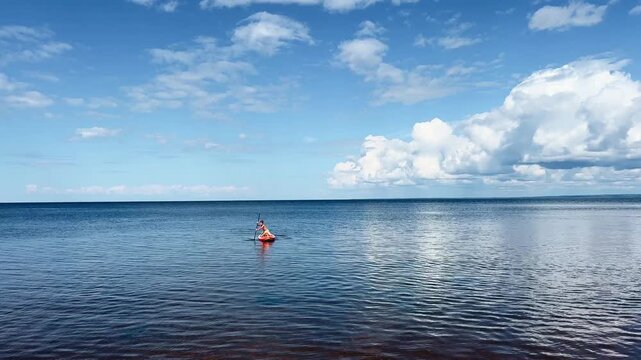 Experience Serene Kayaking at the Peaceful Lake Beneath a Beautiful Summer Sky