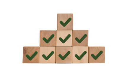 A stack of wooden blocks with green checkmarks, symbolizing accomplishment and success in a playful, creative manner.