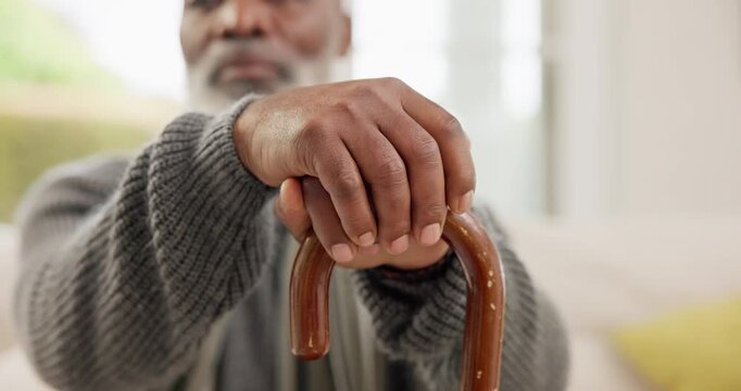 Hands, walking stick and elderly man with disability, rehabilitation support or homecare in retirement. Closeup, lonely senior and wood cane for balance of parkinson, arthritis or help for healthcare