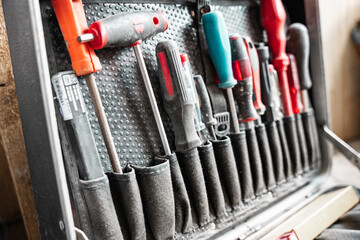 Fototapeta premium Various Work Tools In Little Black Toolbox. Equipment.