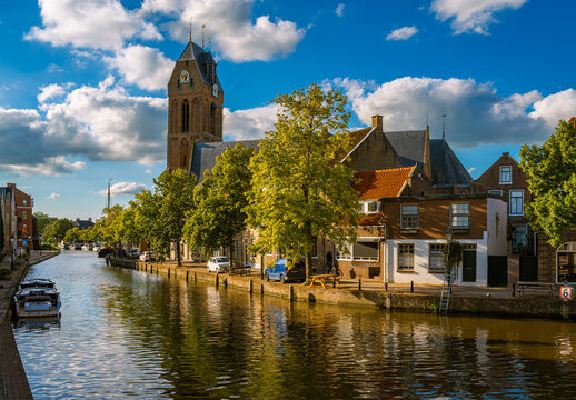 Cityscape of Oudewater, Province Utrecht, The Netherlands, scenery with St. Michaels Church by Hollandse IJssel river on a sunny summer day