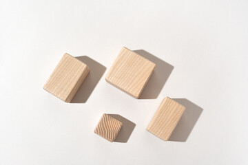 Product presentation background, flat lay, made with natural wooden blocks with hard light. Studio photography.