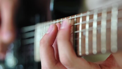 A captivating closeup shot that showcases hands skillfully playing an electric guitar instrument beautifully Close-up of an experienced musician playing electric guitar