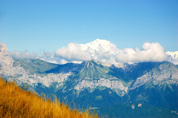 Majestic mountain landscape with Mont Blanc rising over the clouds at background. Annecy lake area, Haute-Savoie, France.