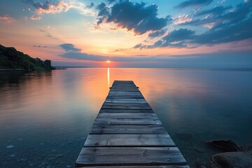 Fototapeta premium A wooden dock stretches out into the calm water, perfect for a relaxing day or a romantic getaway