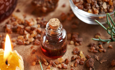 Myrrh essential oil in a transparent glass bottle with myrrh resin