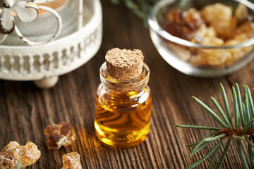 A transparent bottle of frankincense essential oil with boswellia resin
