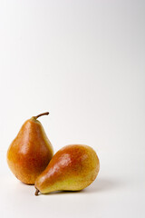 Two ripe pears lie together on a white background