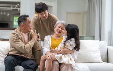 Portrait of happy love family asian father and mother playing with adorable asian kid girl.daughter, care, insurance.Happy family moments good time love with grandparents.Love of big family
