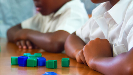 Children Engaged in Learning Activities at a Classroom Table During Daytime