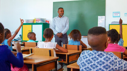 Teacher Engaging Young Students in Classroom Discussion at School