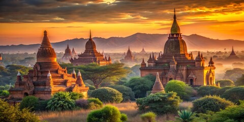Vibrant orange hues illuminate ancient Bagan temples as the sun sets behind them, casting a warm golden light on the serene Myanmar landscape.
