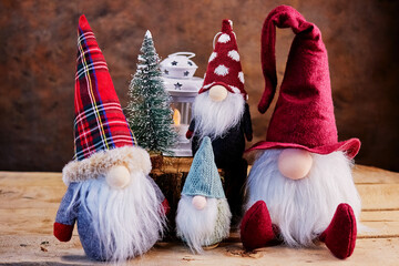 a kind Christmas story about four gnomes with long white beards, in hats and coats in a fairy-tale forest celebrating the New Year with a Christmas tree and a lantern, a holiday card