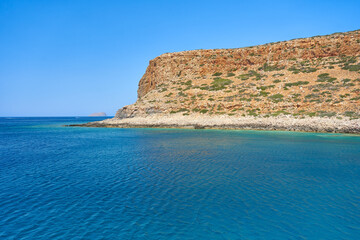 Breathtaking landscape of coast of Mediterranean sea with mountains - Crete, Greece.
Beautiful, clear, blue sky and water. View from a ship on a cruise.