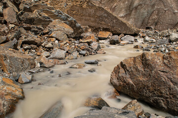 Melt waters of the Becho Glacier. Water flowing from the glacier on Ushba mountain. 
Dolra River in Becho Valley with panoramic views of Ushba Mountain. River photos taken with long exposure.