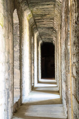 corridor through a stone-walled castle