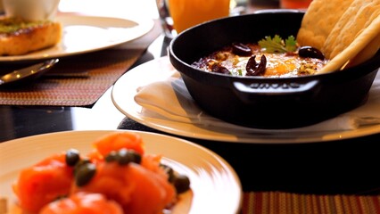 Delicious dish served on white plate featuring salmon, fried eggs, and carrots. VIbrant colors and appetizing arrangement make it perfect for themes of gourmet cuisine and healthy eating.