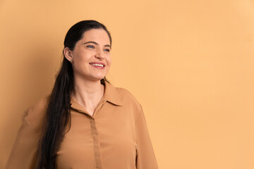happy brazilian woman smiling and standing in studio shot. portrait, real people concept.