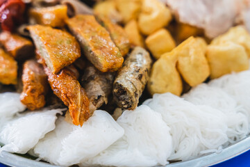 A delicious Vietnamese dish, Bun Dau Mam Tom, is a popular street food made from rice noodles with boiled meat, fried tofu, shrimp paste and green vegetables, cucumber and spices such as chili, lime