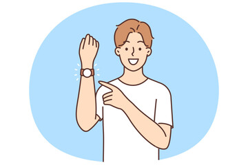 Smiling man point at wristwatch