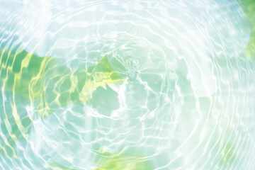 Blue water with ripples on the surface. Defocus blurred transparent blue colored clear calm water surface texture with splashes and bubbles. Water waves with shining pattern texture background.