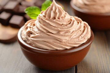 Creamy chocolate mousse dessert with fresh leaves dark chocolate pieces