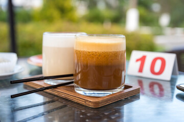 The scene is set in a cafe, with a table and chairs surrounding the tray
